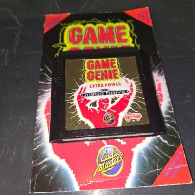 Game Genie cartridge & book for Sega Megadrive